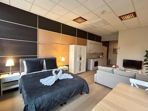 a bedroom with a bed with a bow on it at Cozy independent Studio S2, City Centre Dordrecht in Dordrecht
