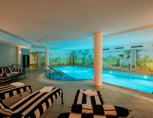a large swimming pool with two beds in a building at Louisa's Place in Berlin