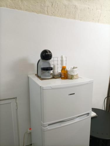 a white refrigerator with a blender on top of it at Newhouse Rooms BLACK & WHITE in Modugno