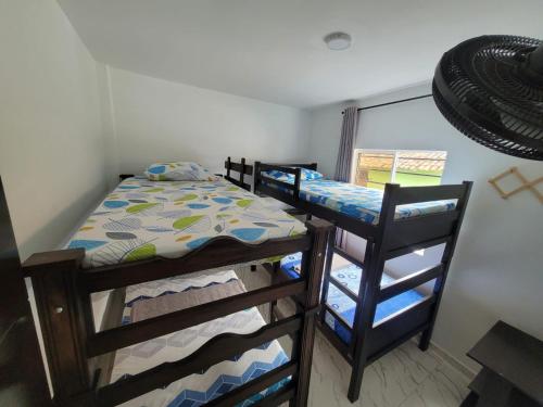 a bedroom with two bunk beds and a window at Apartamento 920 San Gil in San Gil