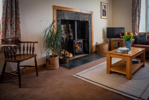 a living room with a fireplace and a couch at Hillside Cottage in Aberdeen