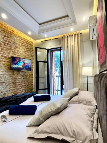 a bedroom with two beds and a brick wall at BellaVista walls House in Tangier