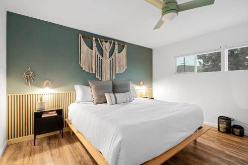 a bedroom with a large white bed in a room at Audreys Place - Hot tub - Fire Pit - Downtown JT in Joshua Tree
