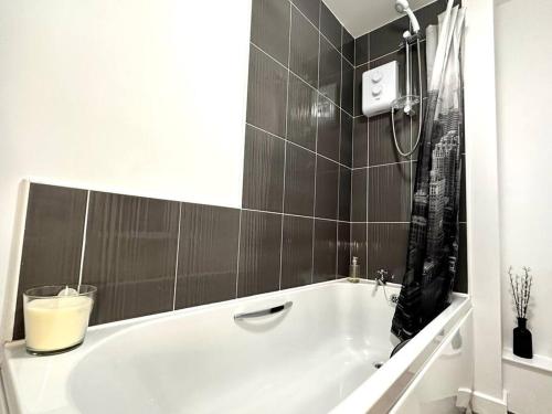 a white bath tub in a bathroom with a shower at Dale House by Blue Skies Stays in Middlesbrough