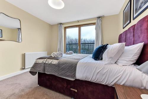 1 dormitorio con 1 cama grande y ventana en Scenic Park View Suite, en Milton Keynes