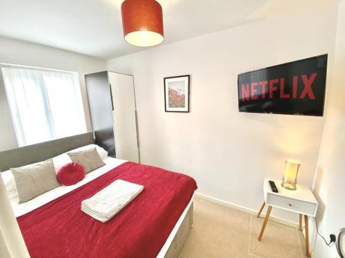 a bedroom with a bed with a red blanket at Walsall group relocation in Walsall