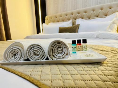 a tray with towels and cosmetics on a bed at Hotel Amayra in Jaipur