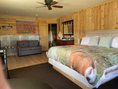 a bedroom with a large bed and a couch at Bryce Canyon Country Inn in Tropic