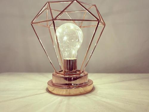 a light bulb in a glass container on a table at Casa di Duccio in Montone