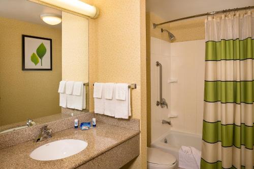 a bathroom with a sink and a toilet and a tub at Fairfield Inn by Marriott New York LaGuardia Airport/Flushing in Queens