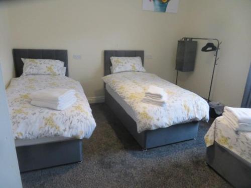 a bedroom with two beds with towels on them at 29 Lewes Road - Darlington in Darlington