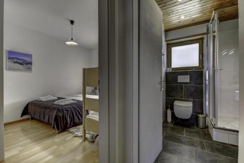 a small room with a bed and a bathroom at Appartement Mont Parrain 4 in La Tzoumaz