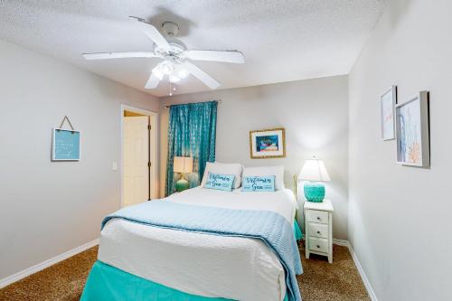 a bedroom with a bed and a ceiling fan at Pretty in Perdido Key in Perdido Key