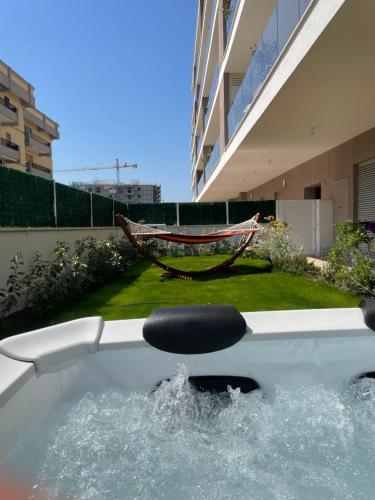 a bath tub with a chair in a yard at Lucia’s House in Bari