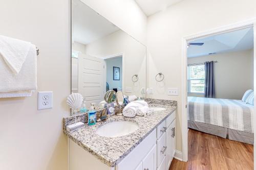 a bathroom with a sink and a mirror at Sun and Sand in Myrtle Beach