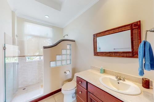 a bathroom with a sink and a toilet and a mirror at Del Pacifico Condo C7 in Bejuco