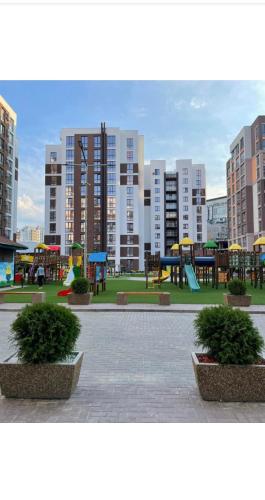 a park with a playground with tables and benches at Сан-Марко in Chişinău