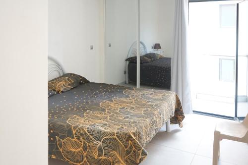 a bedroom with a bed and a mirror at Charming 2 bdr apt, Palmarejo Grande, Praia - LCGR in Praia