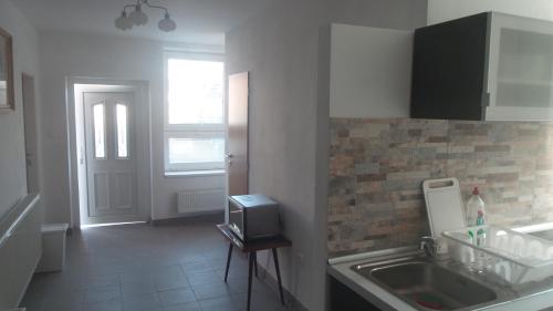 a kitchen with a sink and a window and a door at Ubytovanie v súkromí Mária Bullová in Žilina