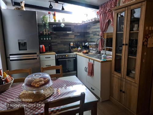 a kitchen with a table with a bowl of food on it at Zoe garden home in Spáta