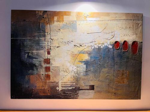 a painting with two red shoes on a wall at Hotel Caney Villa de Leyva in Villa de Leyva