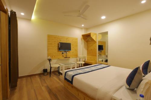 a hotel room with a bed and a desk at The Grand Uddhav- a boutique hotel in Udaipur