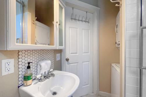 a white bathroom with a sink and a mirror at Greenway Hideaway in Fayetteville