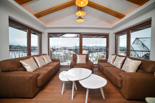 a living room with a couch and a table at Aria Club Wellness&Spa Zlatibor in Zlatibor
