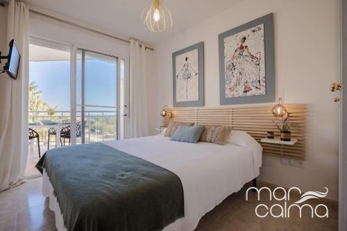 a bedroom with a large bed and a balcony at Apto. Bellavista by MarCalma in Miami Platja