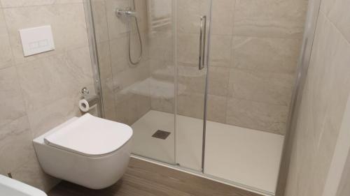 a bathroom with a shower with a toilet and a sink at Hotel Ristorante alla Campagna in San Giovanni Lupatoto