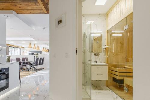 a kitchen with a glass door and a dining room at MountainBase - Widokowy 1 in Kościelisko