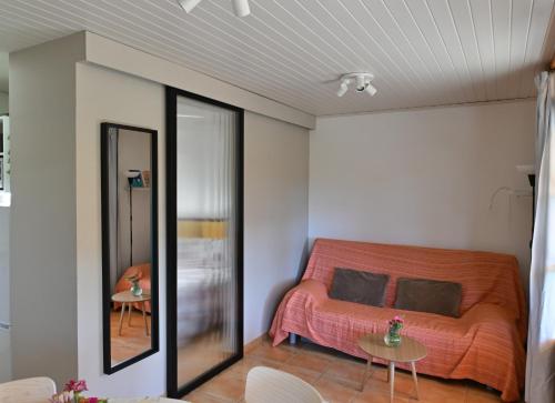 a bedroom with an orange bed and a mirror at Allotjament Rural Solsona in Solsona