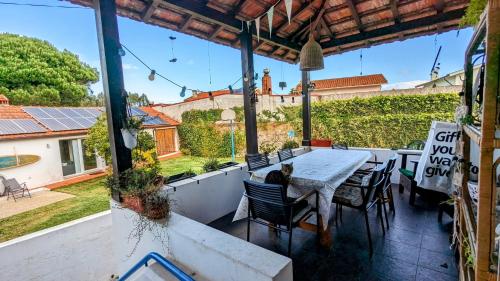 a table and chairs on a patio with a view at Casa do Paço Aveiro Studio&Rooms in Aveiro