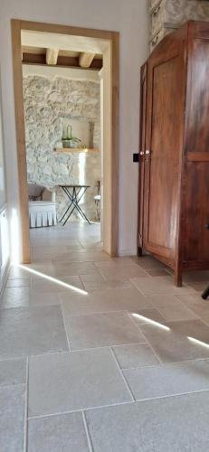 a room with a wooden door and a stone wall at Agriturismo La Pina in Tarzo