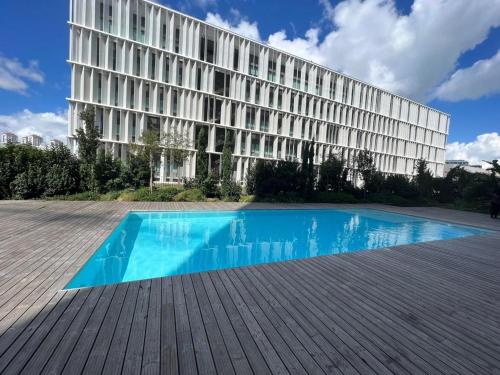 a building with a swimming pool in front of a building at S.Soares T3 Expo Sul in Lisbon