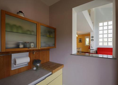 a kitchen with a counter with two mirrors at Olivos Villa Sani in Sani Beach