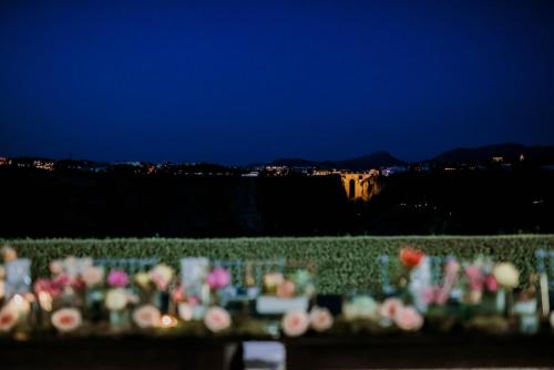 a bunch of flowers sitting on a fence at night at La Marabulla in Ronda