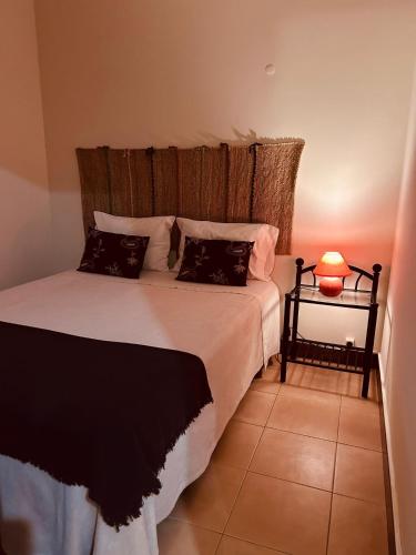 a bedroom with a bed and a lamp on a table at Apartment Salgados T1 in Guia