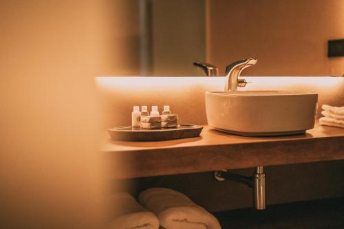 a bathroom counter with a sink and a sink at Get Hotel Molvento, AKEN Soul Collection in Villa General Belgrano