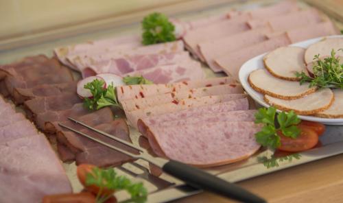 a tray of meats and cheese on a table at Apartment Hotel Konstanz in Konstanz