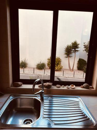 a kitchen sink with a view of a window at Apartment Salgados T1 in Guia