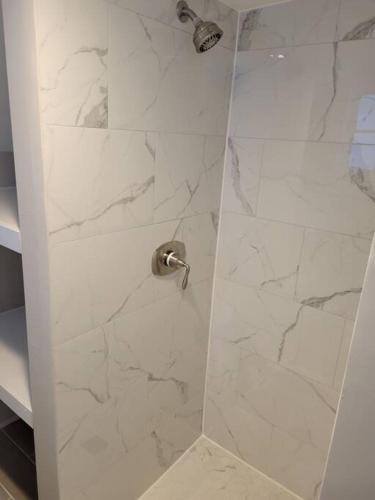 a shower with a glass door in a bathroom at Annapolis @Gate 1 steps to the Harbor Free parking in Annapolis