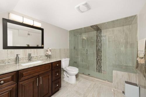 a bathroom with a toilet and a glass shower at Walk-out Basement with Private Entrance in Brampton