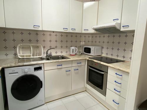 a small kitchen with a sink and a dishwasher at T1 Manta Rota in Manta Rota