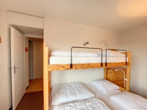 two bunk beds in a room with a hallway at Appartement Montvalezan-La Rosière, 2 pièces, 5 personnes - FR-1-275-191 in Montvalezan