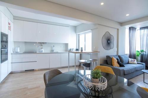 a living room with a couch and a table at NEW - Luxury & bright apartment Lisbon in Lisbon