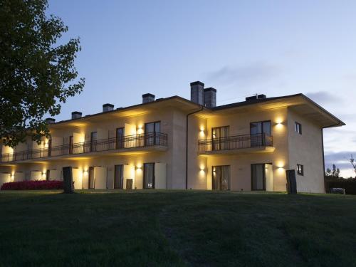 a large white house with its lights on at Hotel Spa Attica21 Vilalba in Villalba