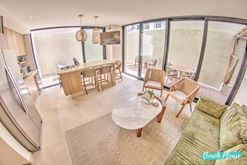 an open living room with a table and a kitchen at Arenka - 2BR w Private Pool & Sunset Rooftop in Bucerías