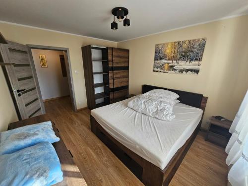 a bedroom with two beds and a window at Nowa piaskowa apartament in Wągrowiec