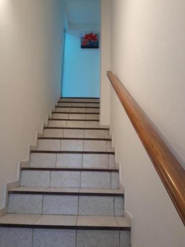 a hallway with stairs with a blue door at Duplex Céntrico in Mendoza